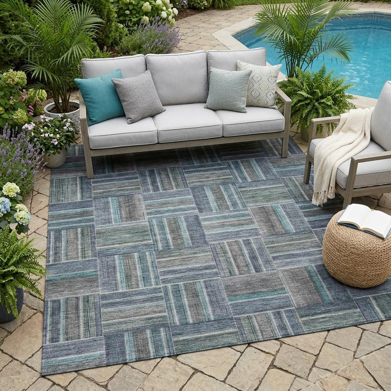 Teal blue and gray geometric indoor outdoor area rug on a rectangular layout