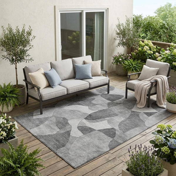 Gray and silver abstract area rug with low-pile texture, shown in a living space