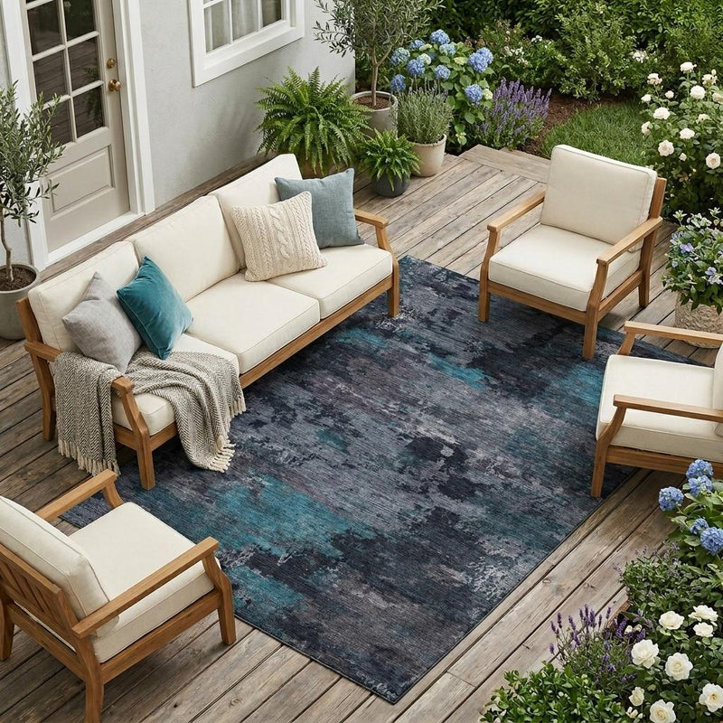 Rectangular teal and graphite abstract area rug for indoor or outdoor use.