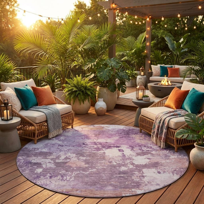 Round abstract area rug in purple and plum tones with mottled distressed pattern