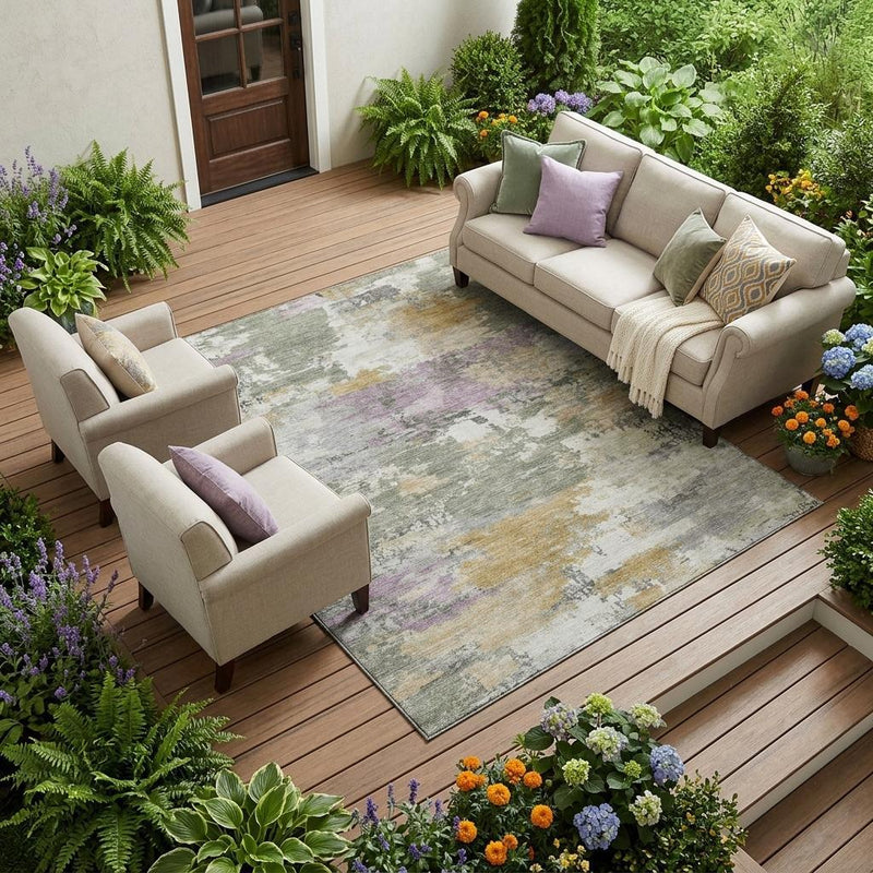 Abstract indoor/outdoor area rug with sage green and gray tones under outdoor seating.