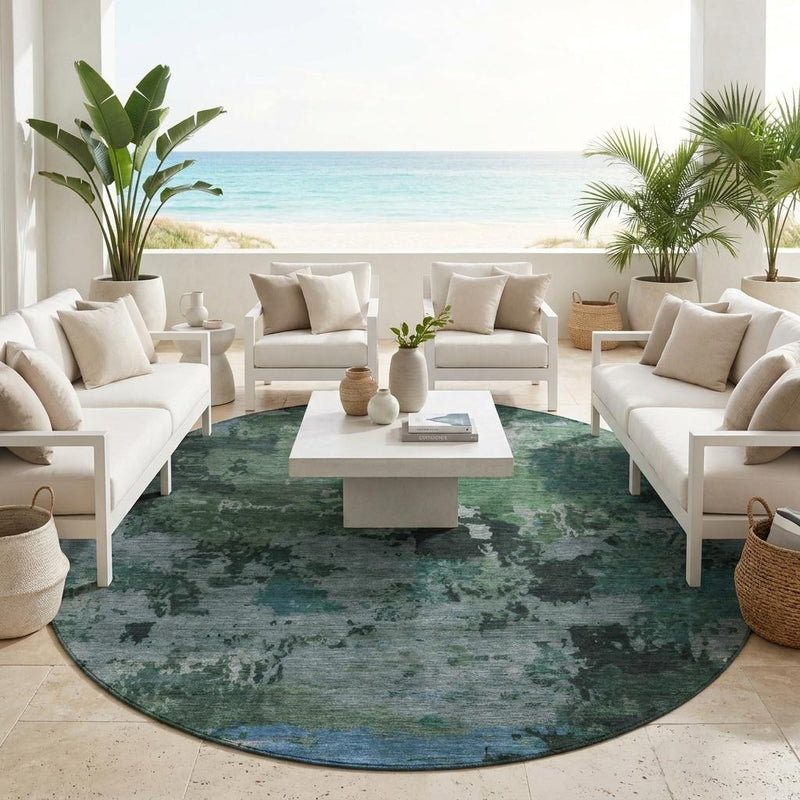 Round abstract area rug, green gray and blue distressed pattern centered on floor