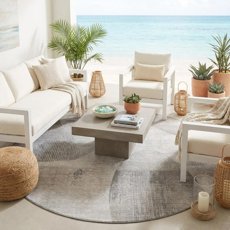 Round abstract area rug with gray and taupe geometric pattern