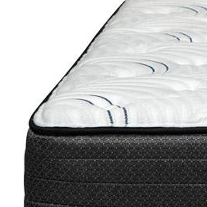 Corner closeup of RV king mattress with white quilted surface and dark border