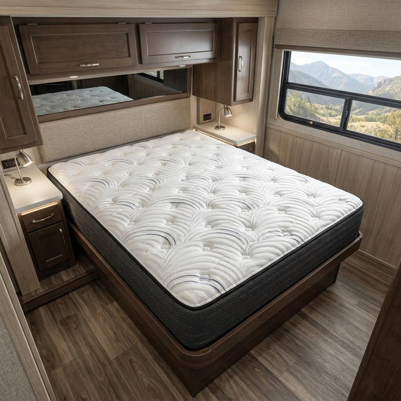 Extra-firm RV king mattress in travel trailer bed, white quilted top, dark sides