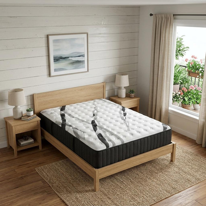 Hybrid mattress on wooden bed frame with white quilted top and dark charcoal sides