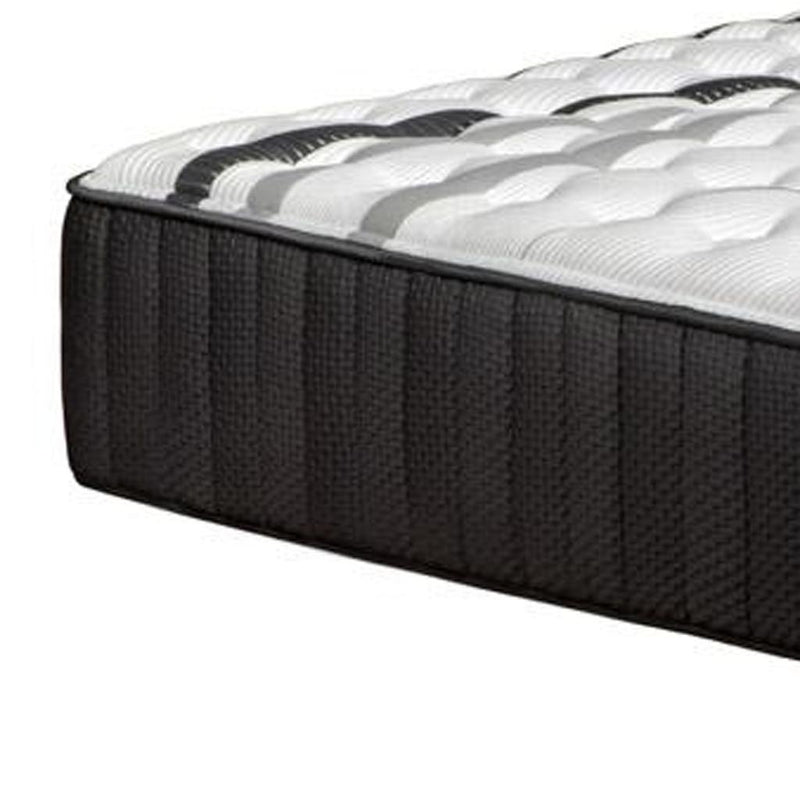 Hybrid mattress side view with textured dark charcoal fabric and white quilted top