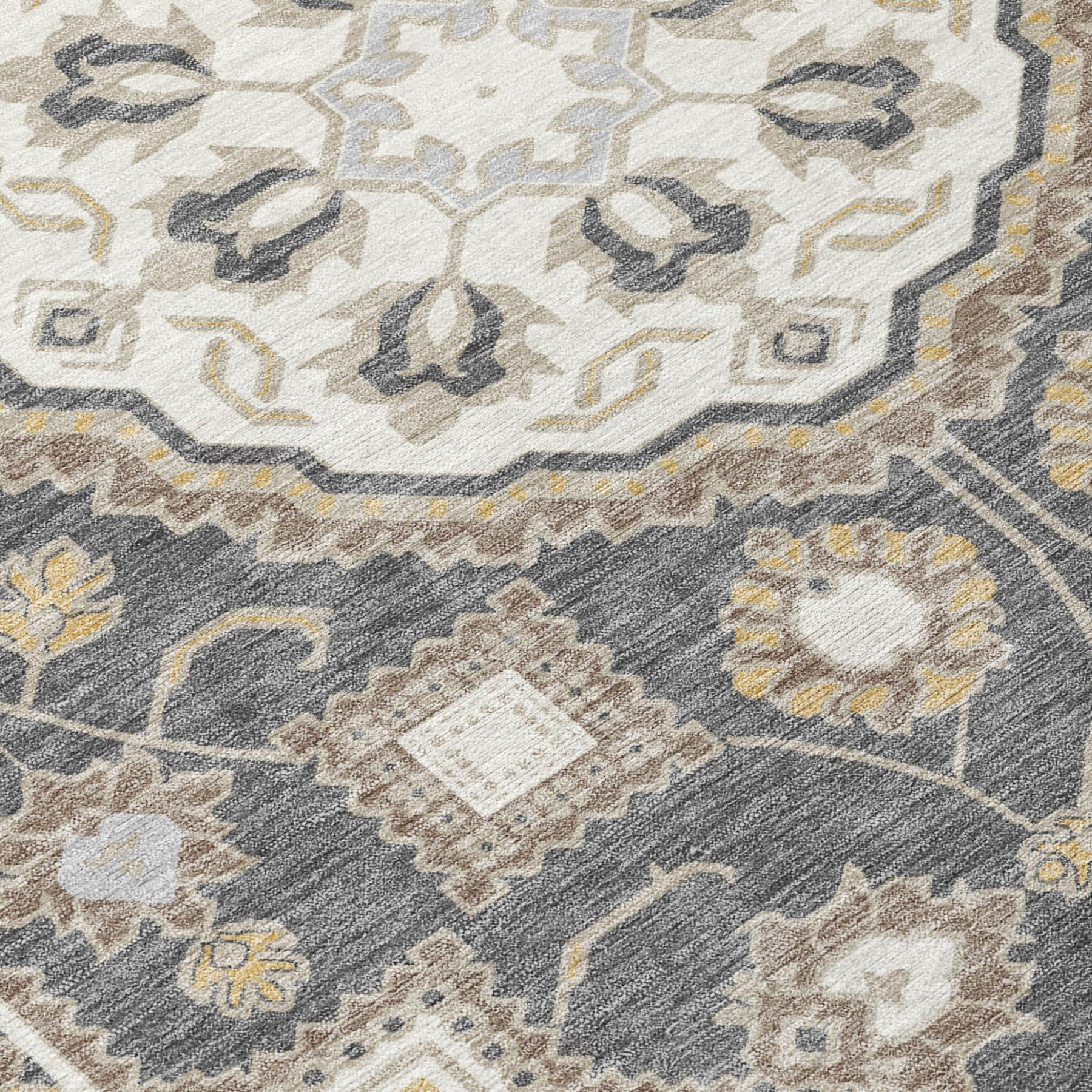Close-up of graphite and gray area rug with floral medallion and scrolling motifs