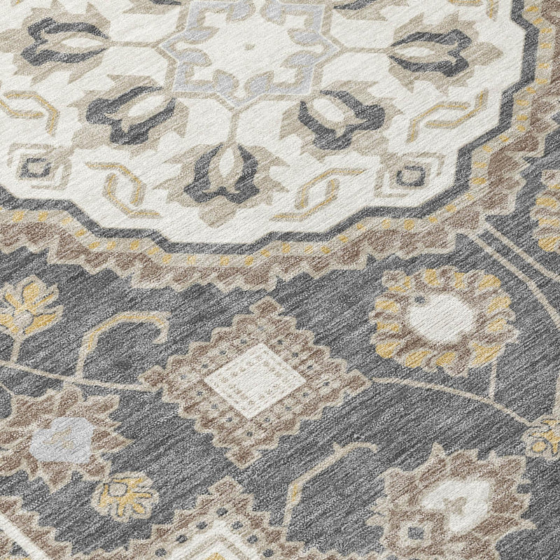 Close-up of graphite and gray area rug with floral medallion and scrolling motifs