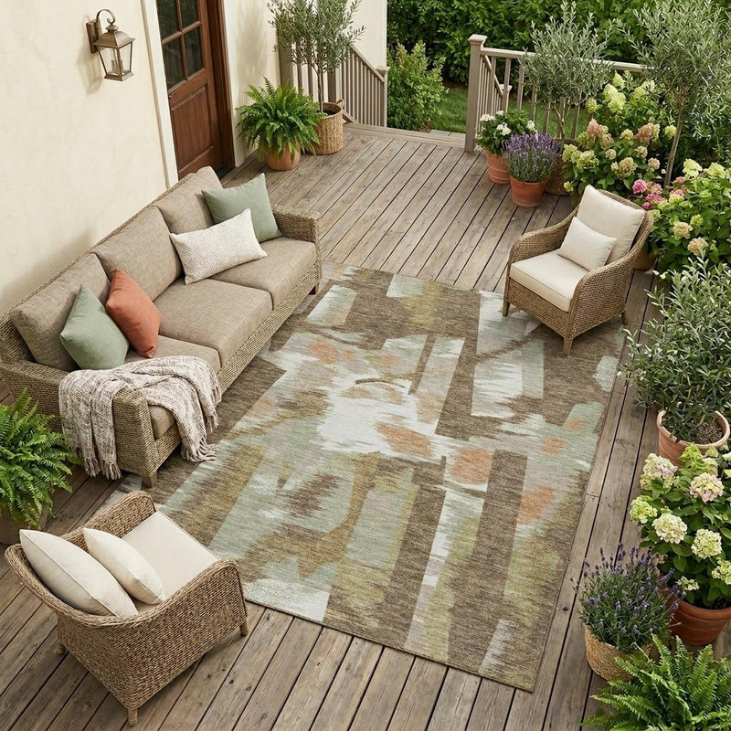 Brown and beige abstract area rug laid on outdoor wood deck with matching patio seating