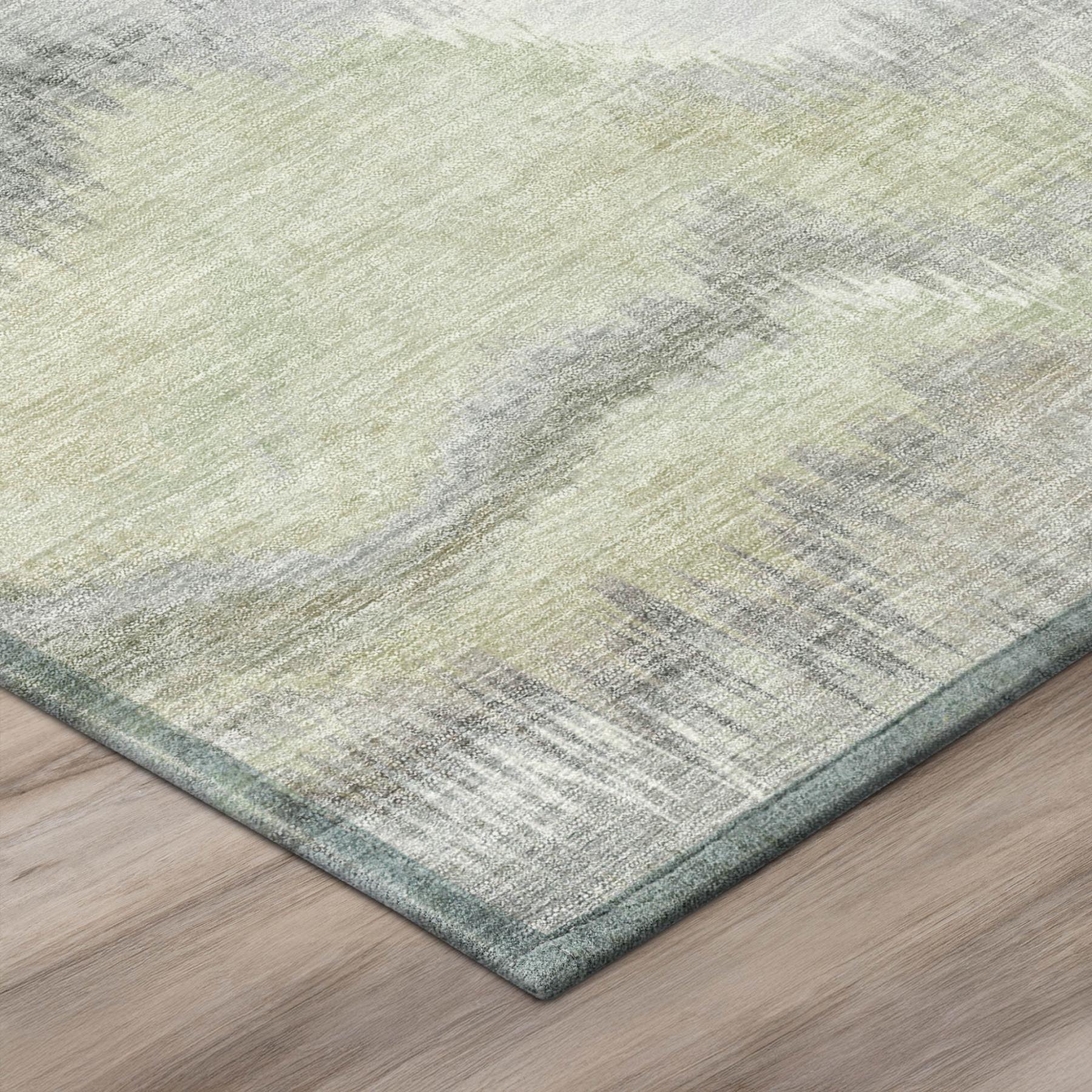 Green, ivory, and gray abstract area rug with washed watercolor pattern and bound edges
