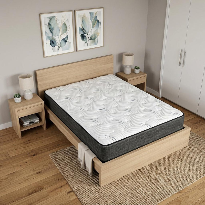 King hybrid mattress on light wood bed frame, white quilted top and dark sides