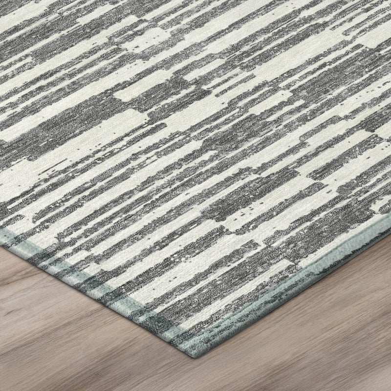 Light gray and graphite striped area rug with textured, distressed lines