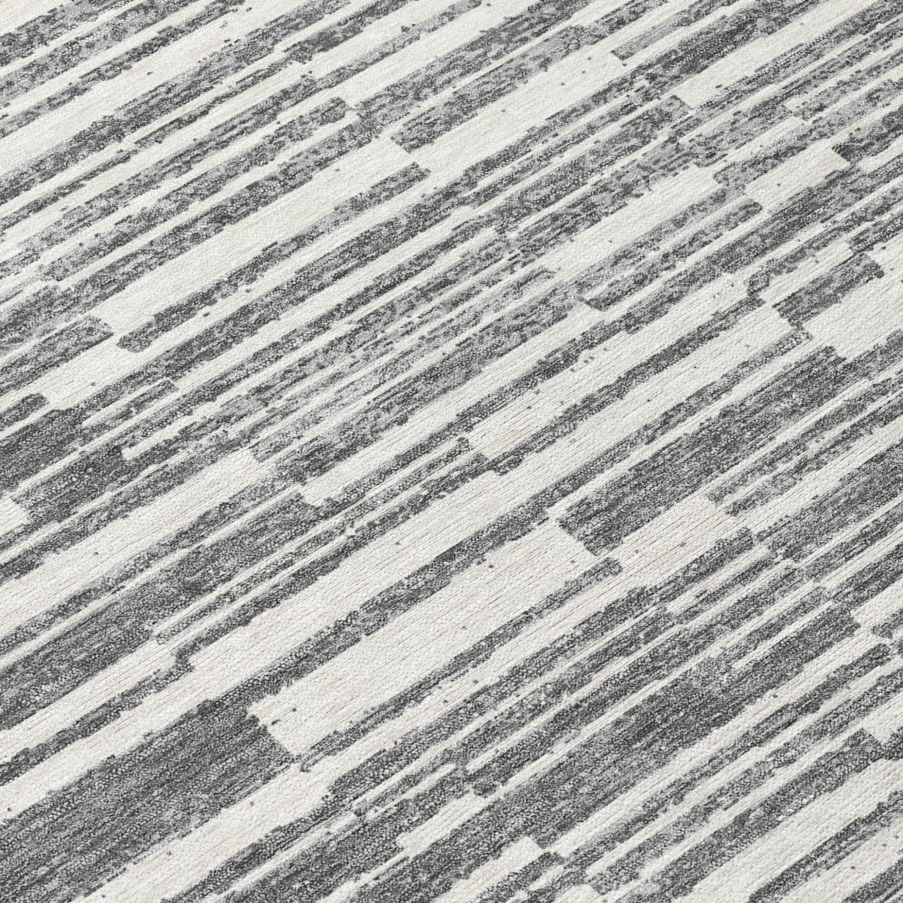 Close-up of graphite and gray striped area rug with textured, distressed lines