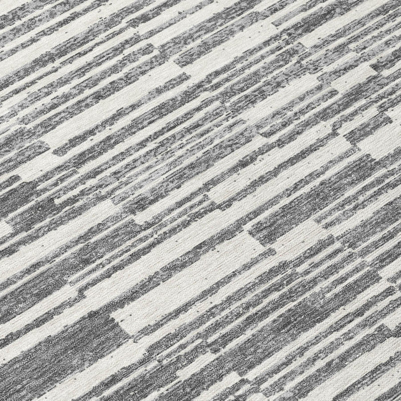 Close-up of graphite and gray striped area rug with textured, distressed lines