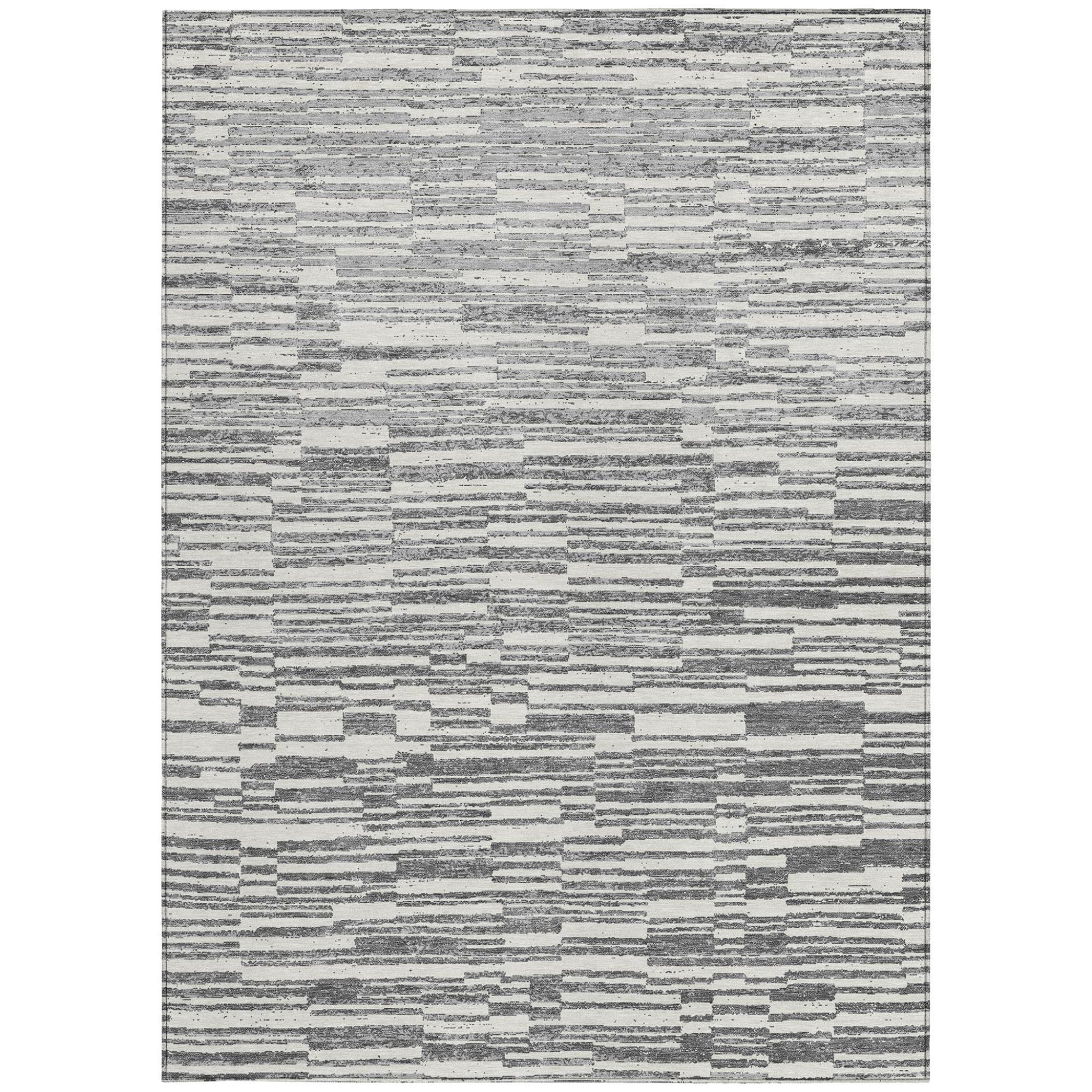 Rectangular light gray and graphite striped area rug with speckled distress