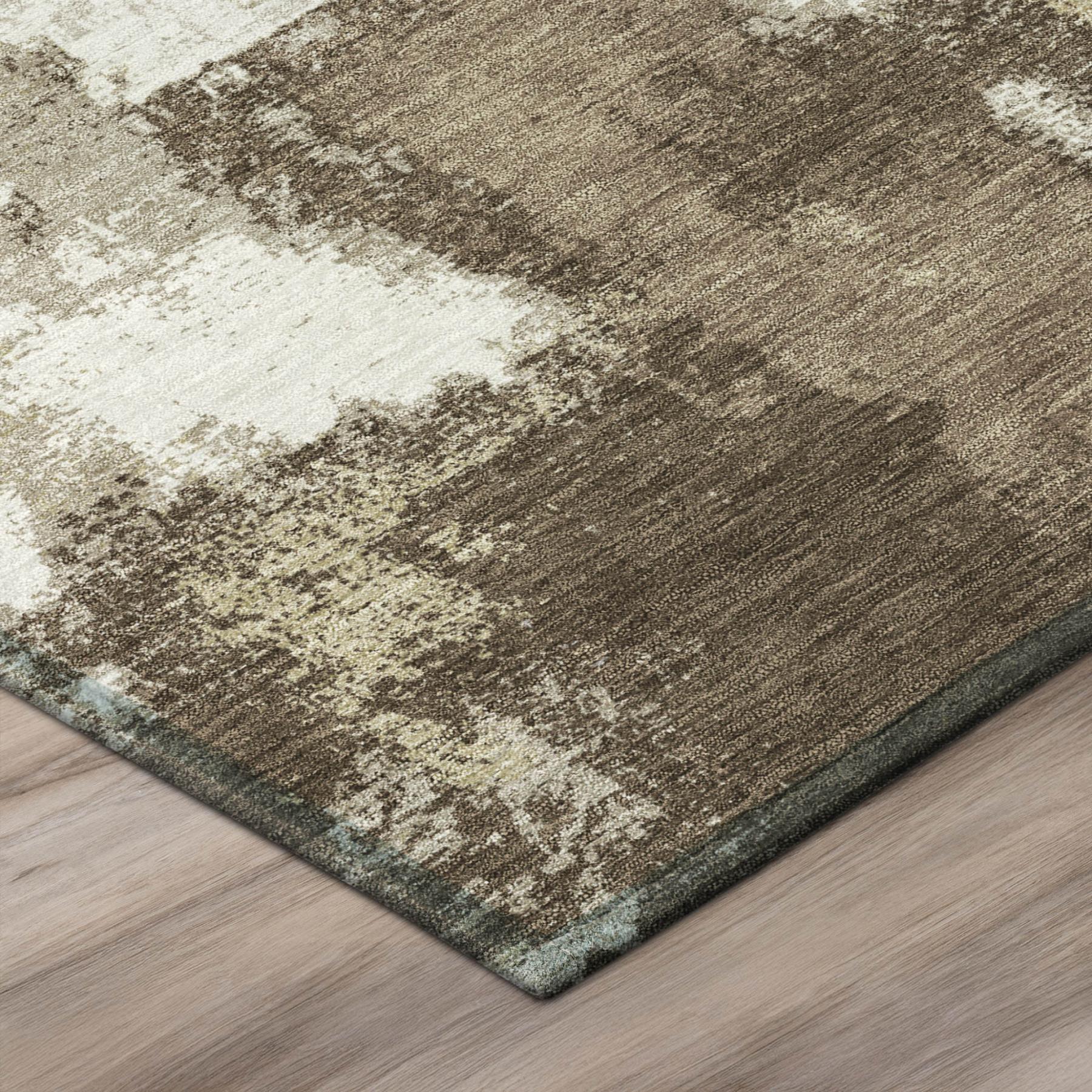 Abstract area rug corner with dark border edge and distressed brown-and-cream pattern