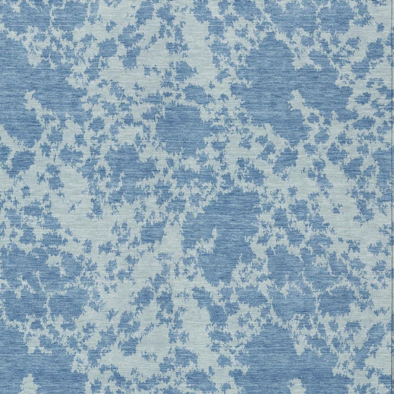 Close-up of sky-blue abstract area rug with light-cream distressed motifs