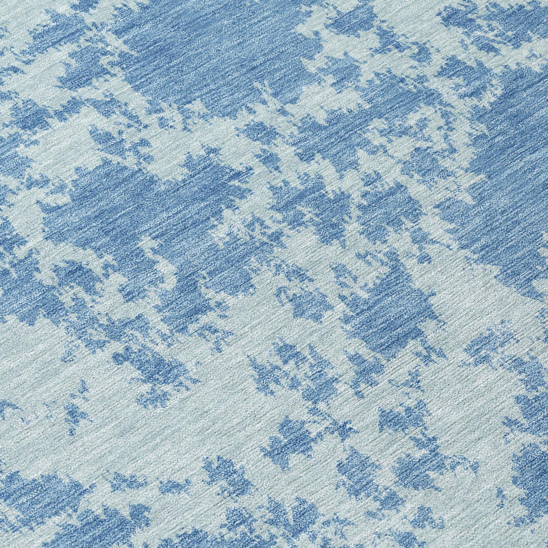Blue abstract area rug close-up showing textured high-low weave
