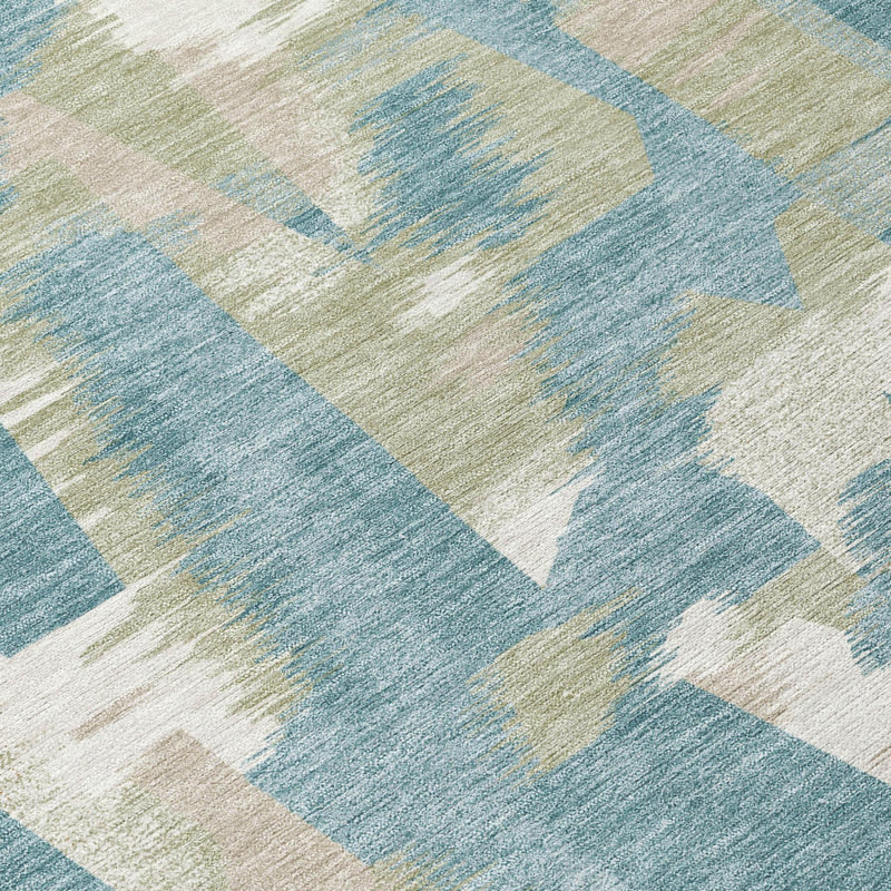 Teal blue abstract rug with overlapping beige, cream, and white block shapes