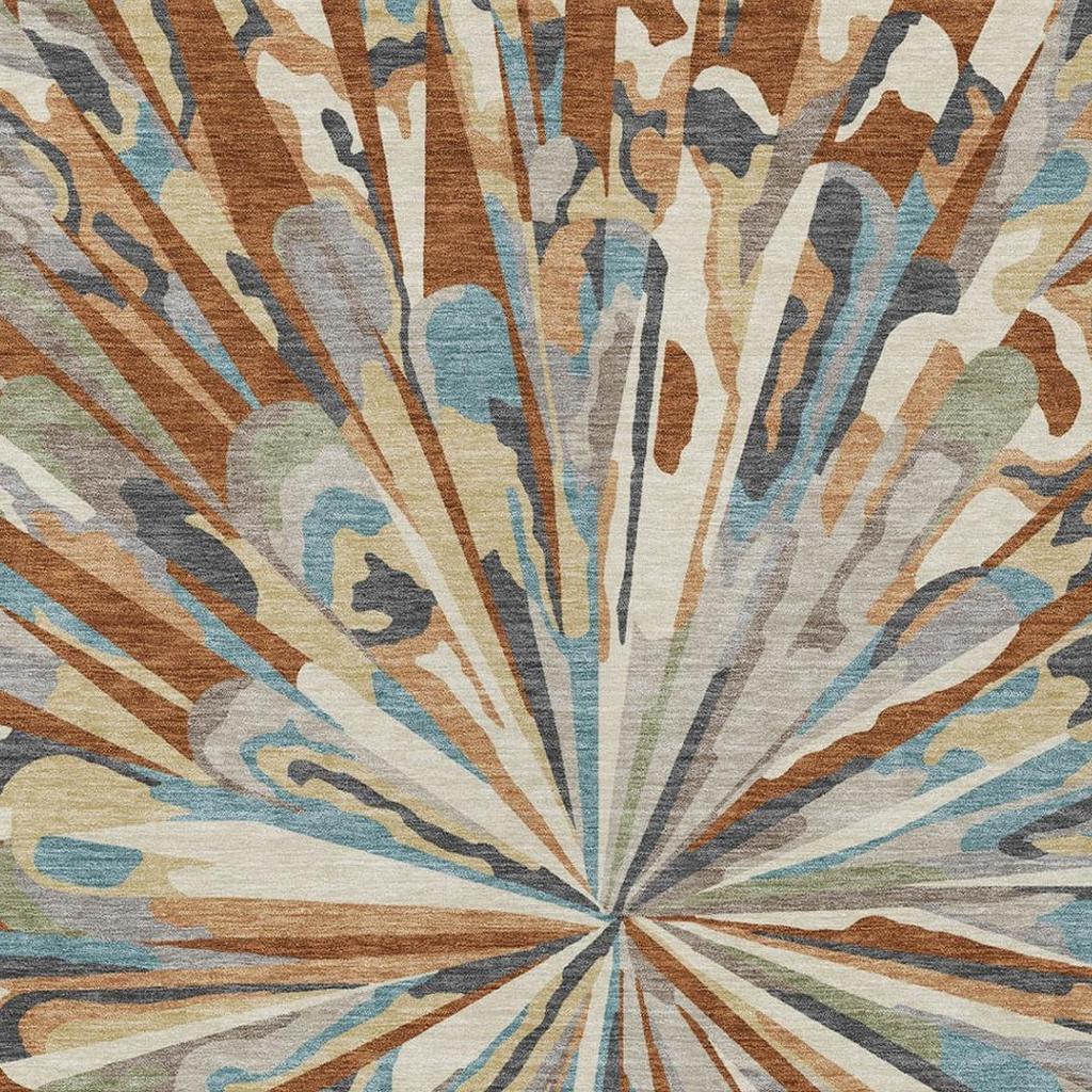 Abstract indoor/outdoor area rug with radial sunburst pattern in teal, orange, and beige tones