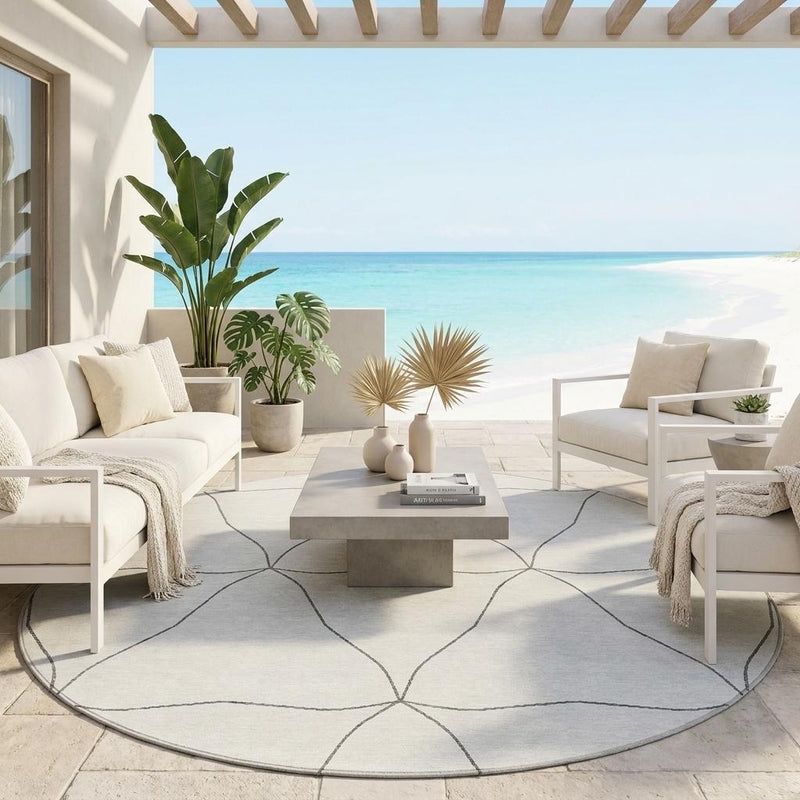 Round indoor/outdoor area rug with navy and light geometric line pattern