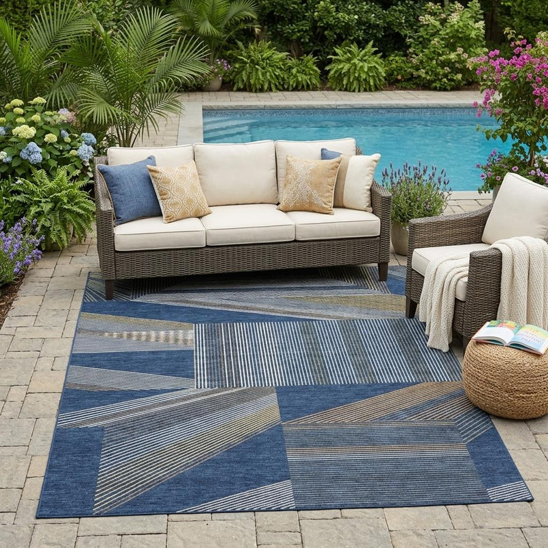 Blue geometric patchwork area rug with striped blocks for indoor or outdoor use