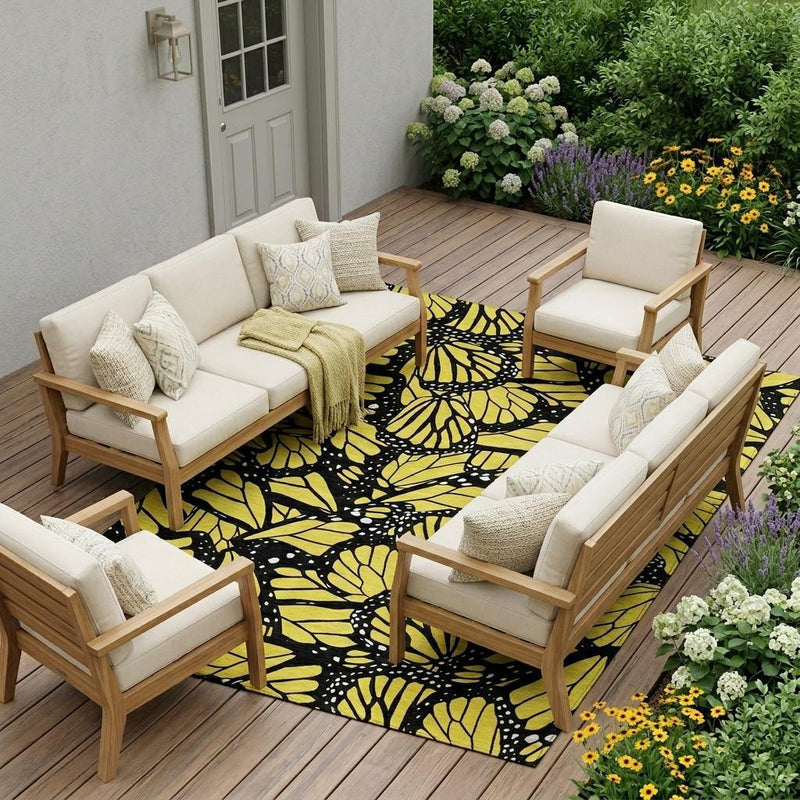Outdoor indoor yellow and gold animal print area rug under patio seating, rectangular shape
