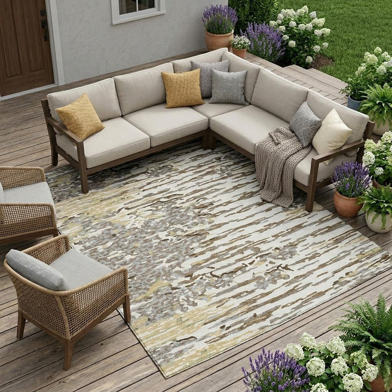 Ivory and silver abstract area rug under outdoor seating, corner and edge visible.