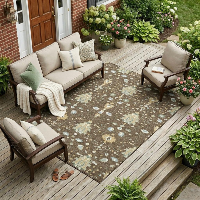 Brown oriental area rug on outdoor wooden deck with cream and light blue floral motifs