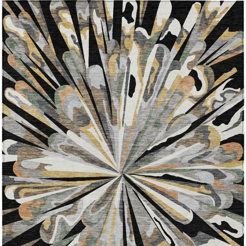 Abstract area rug with radial starburst pattern in black, gray, tan, and gold tones.