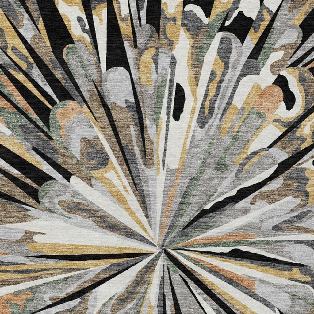 Abstract area rug close-up showing the central burst and radiating lines in dark and neutral tones.