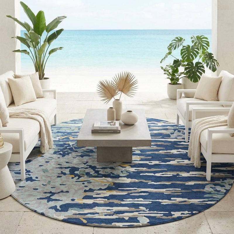 Round washable area rug with navy-blue abstract design on the floor