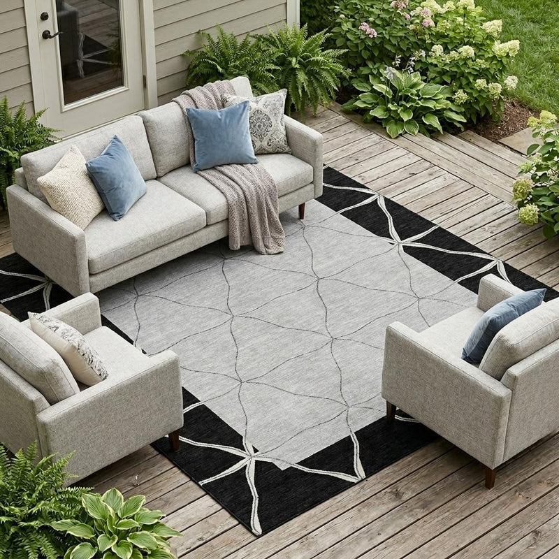 Indoor outdoor geometric area rug with black frame and silver diamond lattice
