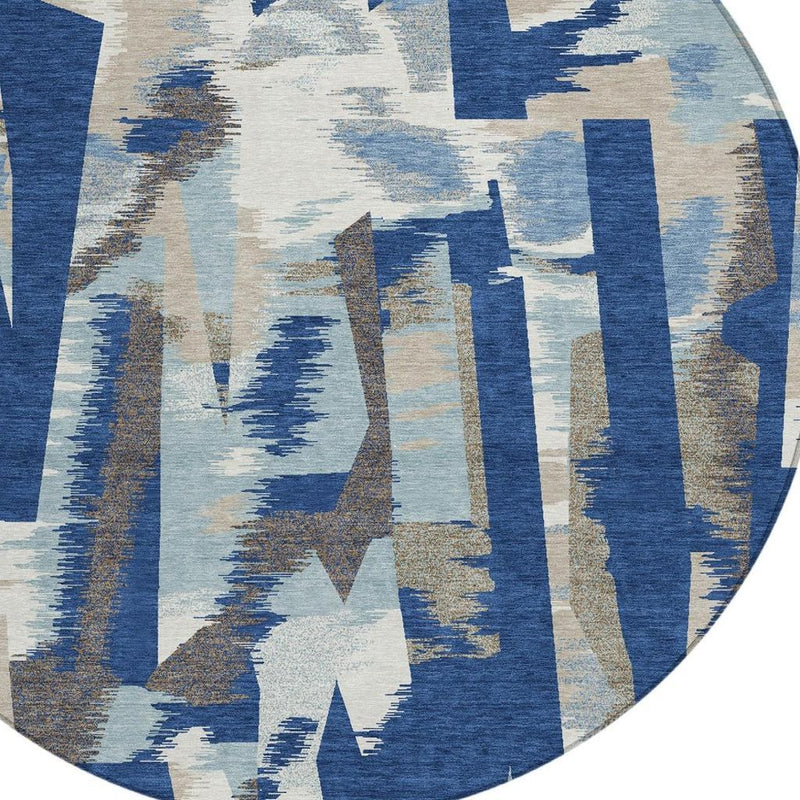 Round abstract area rug with blue and beige brushstroke pattern