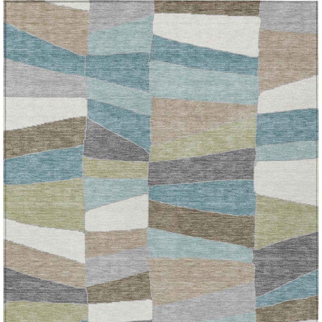 Geometric area rug with interlocking patchwork squares in teal, beige, gray, and white