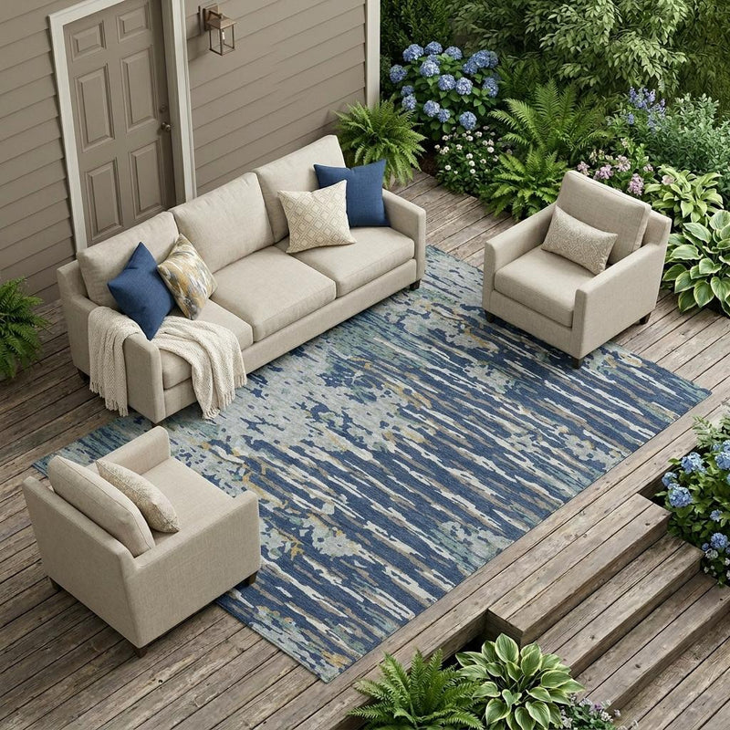 Navy and blue abstract indoor/outdoor area rug with distressed stripes, outdoor patio view
