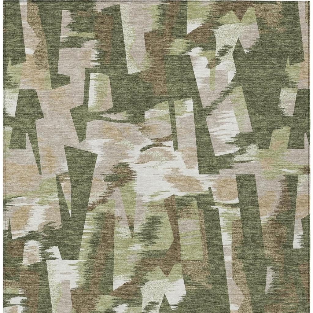 Olive green abstract rug with off-white and beige angular shapes and distressed texture