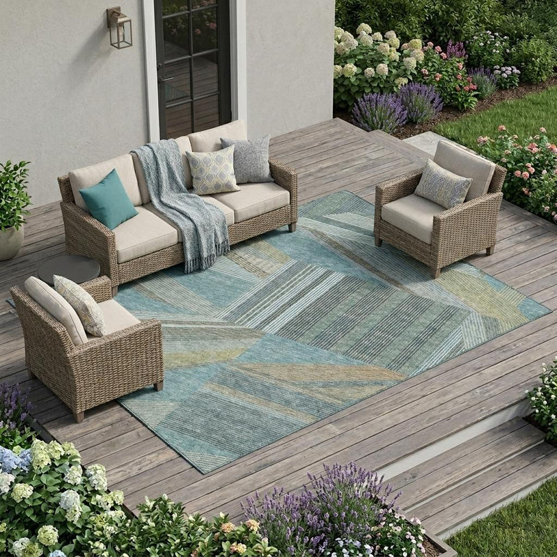 Teal blue geometric area rug on an outdoor patio with multi-color stripe pattern