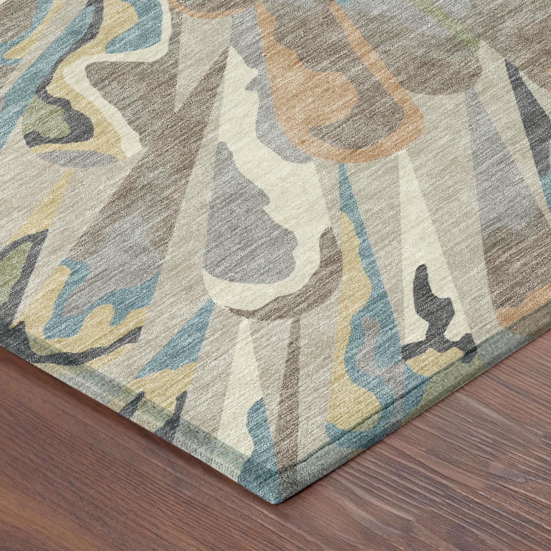 Abstract area rug corner with beige base and blue-green and tan curving ray pattern