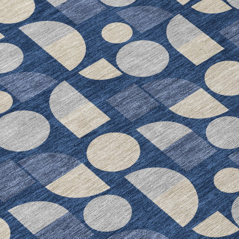 Close-up of navy blue area rug with beige circles and squares pattern