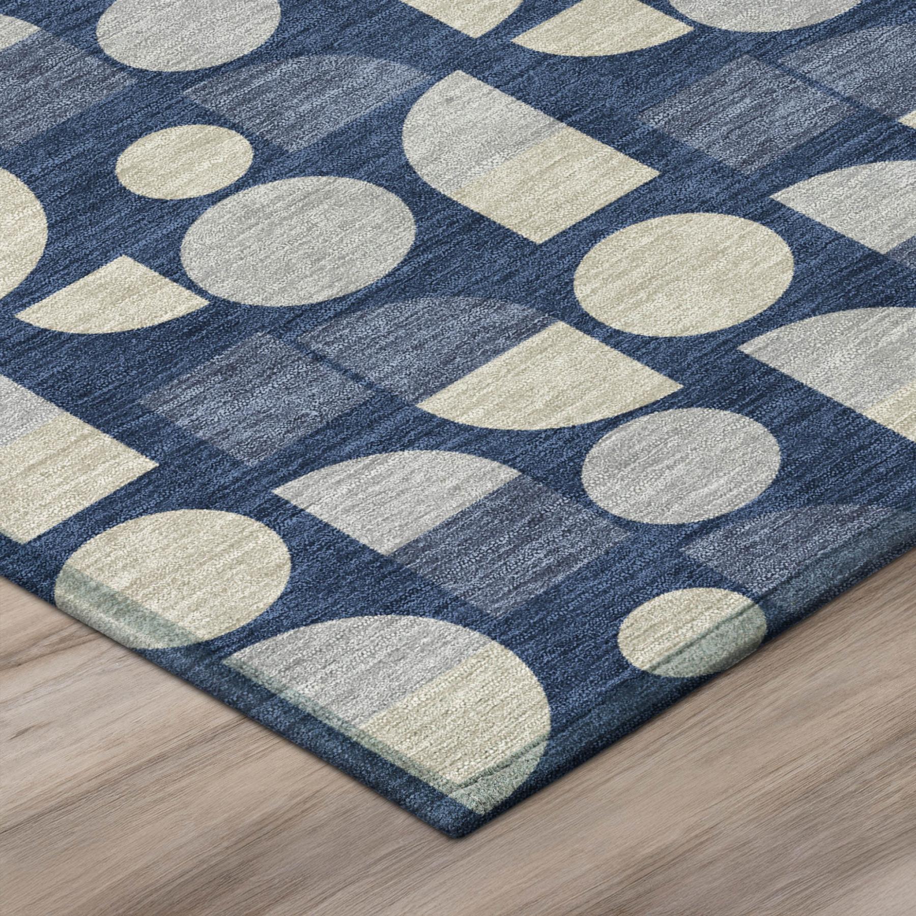 Corner view of navy blue area rug with beige circular and diamond pattern