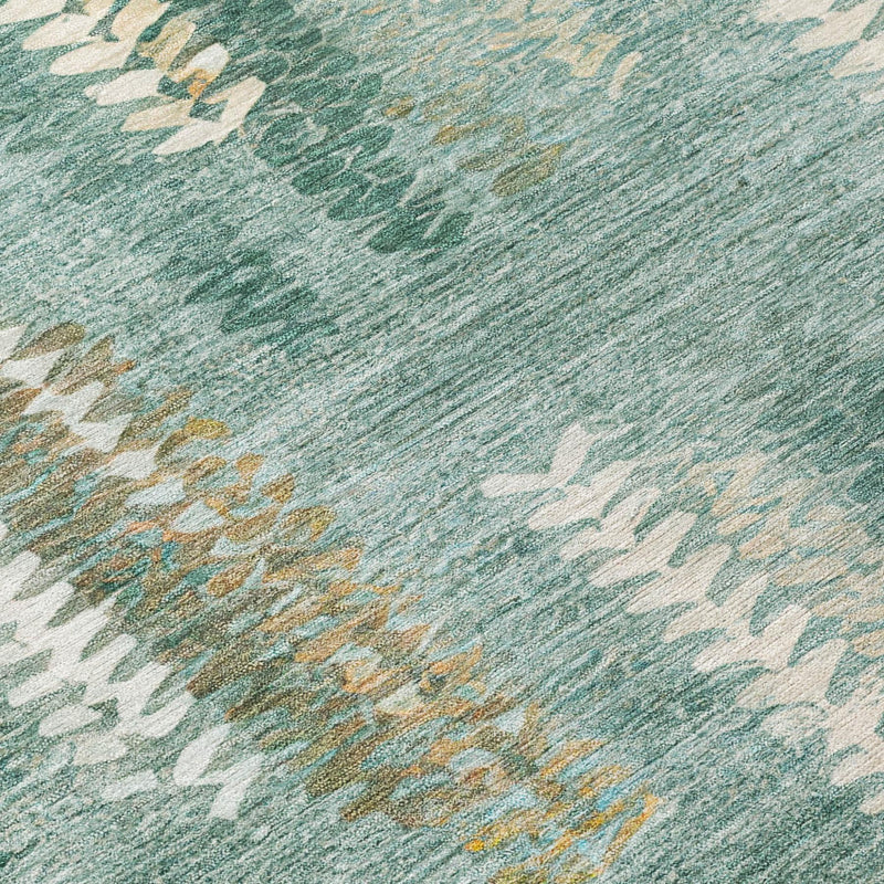 Close-up of teal area rug with cream and tan abstract chevrons