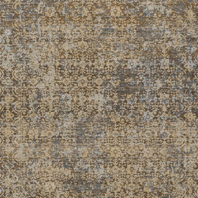 Distressed abstract area rug surface with tan, brown, and faded blue tones