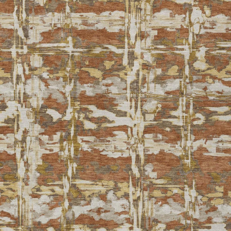 Abstract area rug close-up with orange-brown blocks, cream lines, and distressed pattern