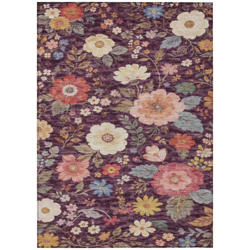 Floral area rug with plum background and peach, cream, and orange flowers in scrolling vines