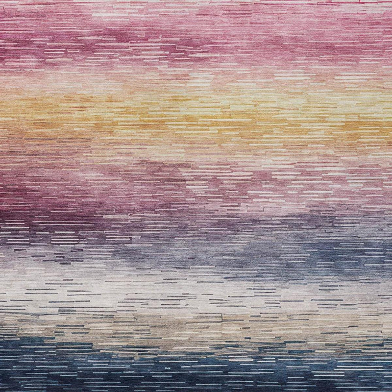 Striped area rug close-up with blush, pink, gold, and navy horizontal bands
