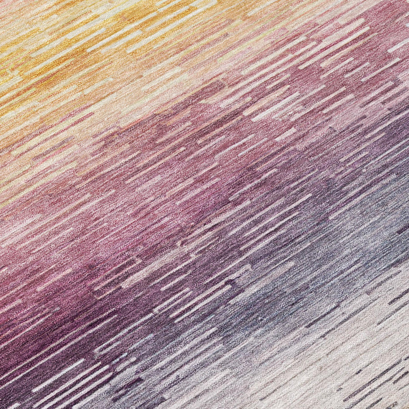Striped area rug close-up in blush pink, maroon, gray, and navy horizontal textures