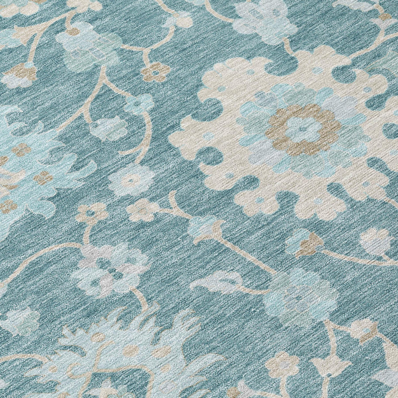 Teal blue floral area rug fabric detail with lighter distressed motifs