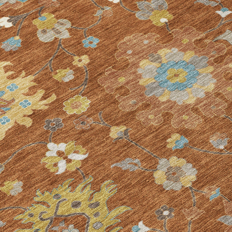 Detail view of rust-brown rug showing scattered flower designs and light blue accents